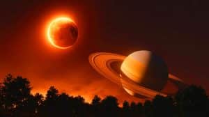 Illustration de l'éclipse totale de Lune avec la planète Saturne visible à ses côtés.